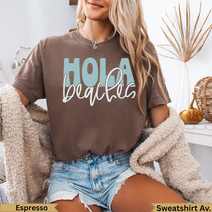 Brown t-shirt with "Hola beaches" in blue and white text.
