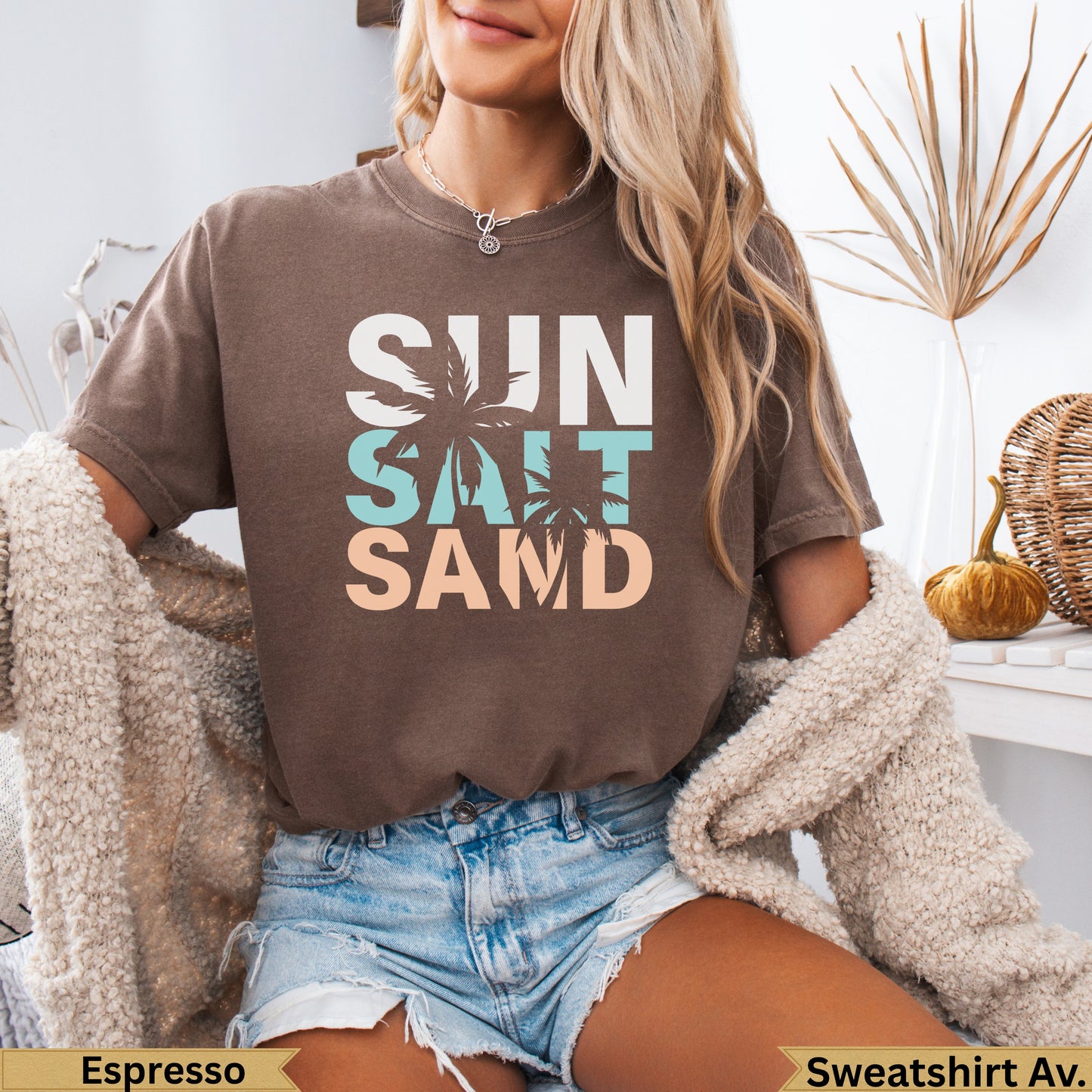 Brown t-shirt with "Sun Salt Sand" text and a palm tree graphic.