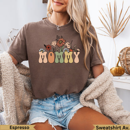 Brown t-shirt with "Mommy" in colorful block letters and floral accents.