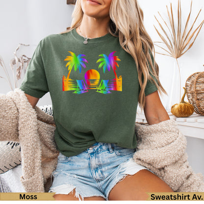 T-shirt with rainbow palm trees, beach chairs, and sunset graphic.