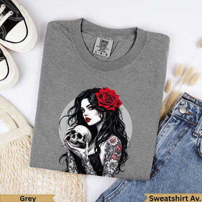 Grey crewneck sweatshirt with tattoo-covered woman holding skull, red rose in hair.