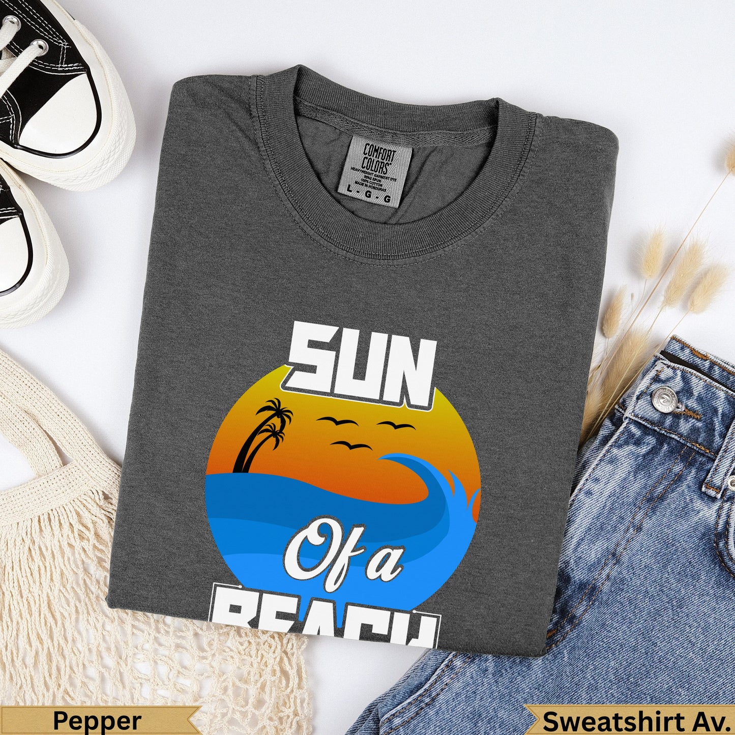 Dark grey graphic t-shirt with "SUN Of a BEACH" text and ocean wave design.