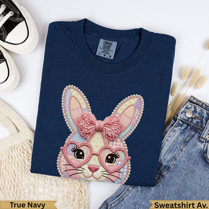 Navy crewneck sweatshirt with embroidered bunny wearing heart glasses and pink bow.