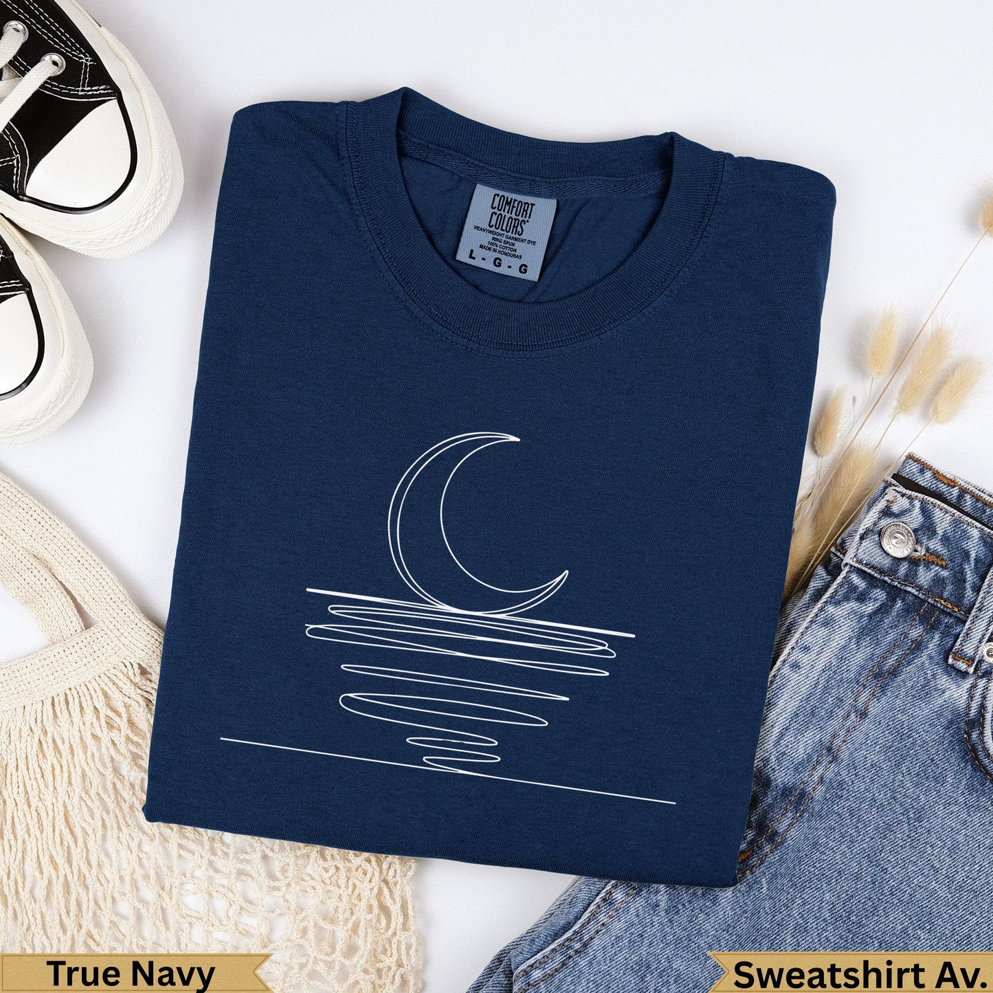 Navy sweatshirt with white line art of moon over water.