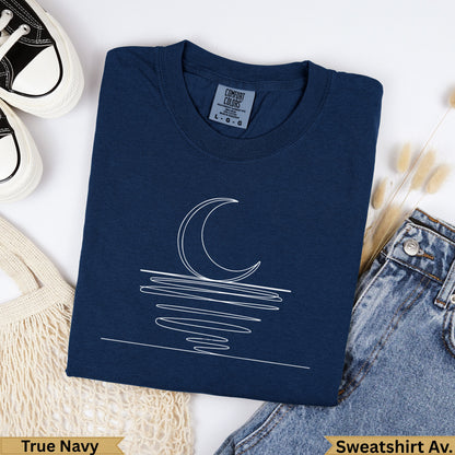 Navy sweatshirt with white line art of moon over water.