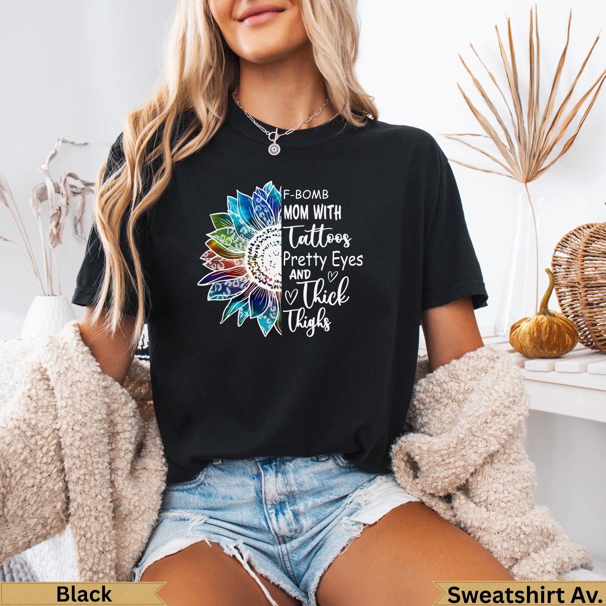 Black t-shirt with sunflower design and text "F-BOMB MOM WITH Tattoos Pretty Eyes AND Thick Thighs".