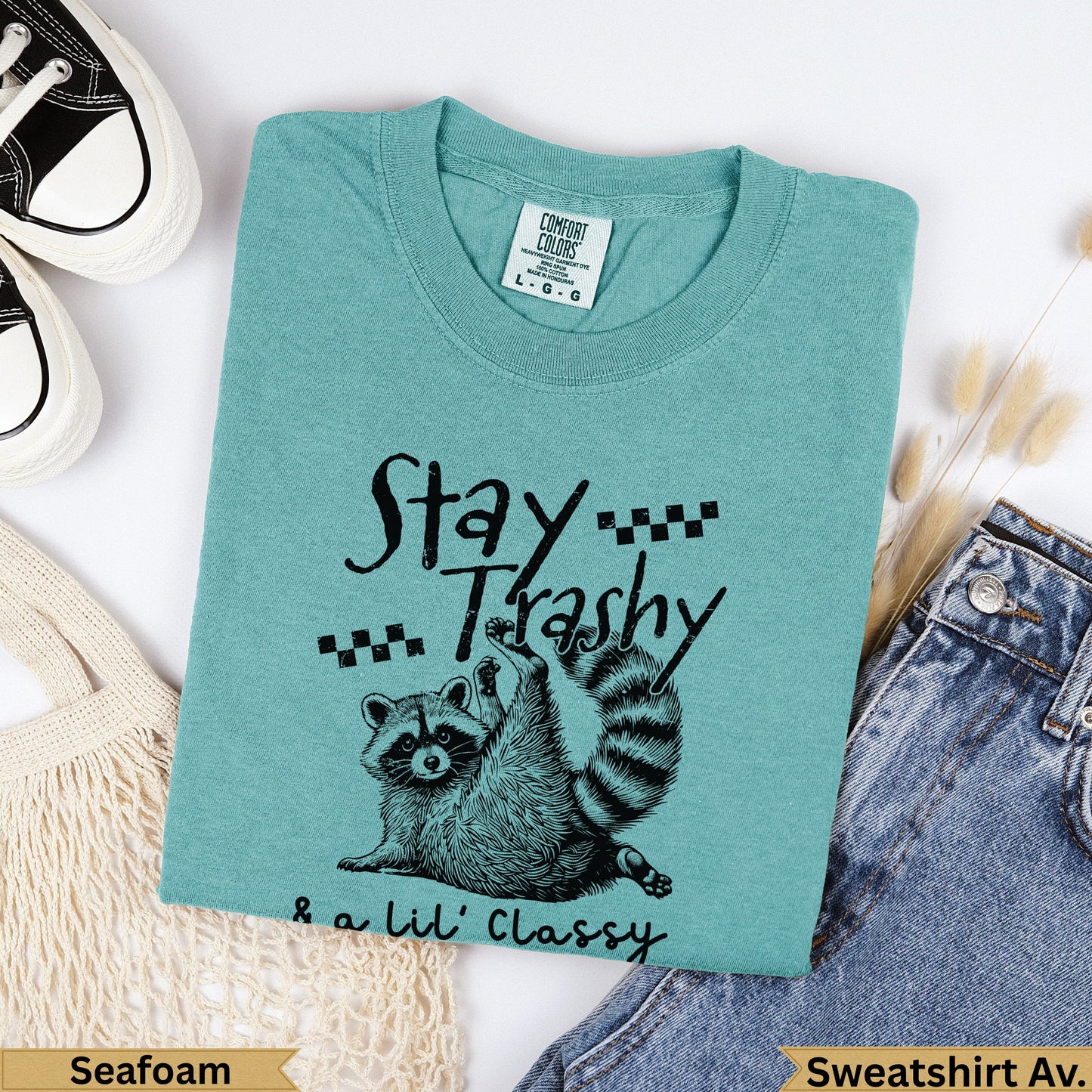 Teal sweatshirt with "Stay Trashy & a Lil' Classy" and raccoon graphic.