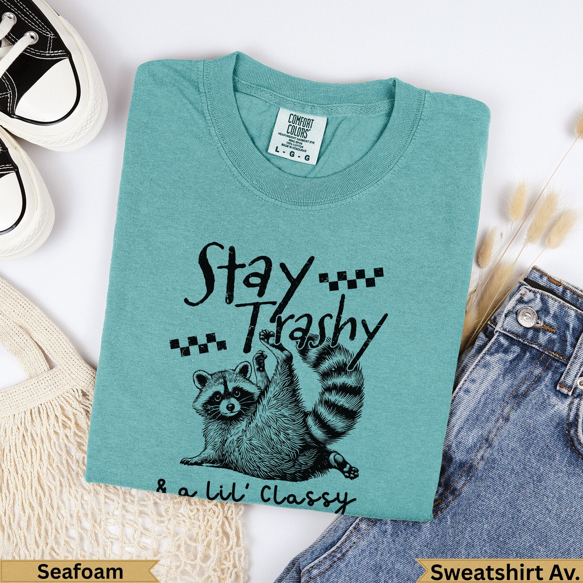 Teal sweatshirt with "Stay Trashy & a Lil' Classy" and raccoon graphic.