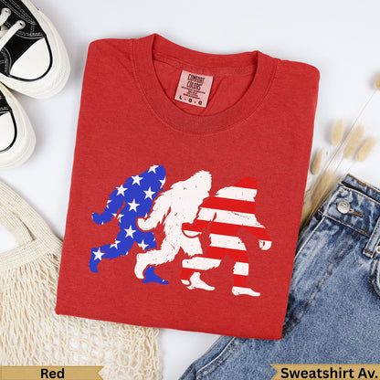Red t-shirt with three Bigfoot silhouettes, two in American flag pattern.