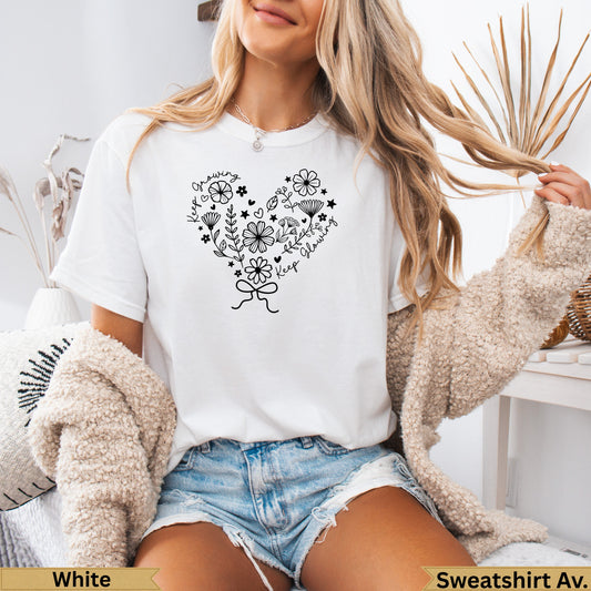 White t-shirt with heart-shaped floral graphic and text.