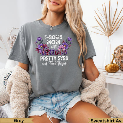 Grey t-shirt with floral "F-BOMB MOM with Pretty Eyes and Thick Thighs" text.