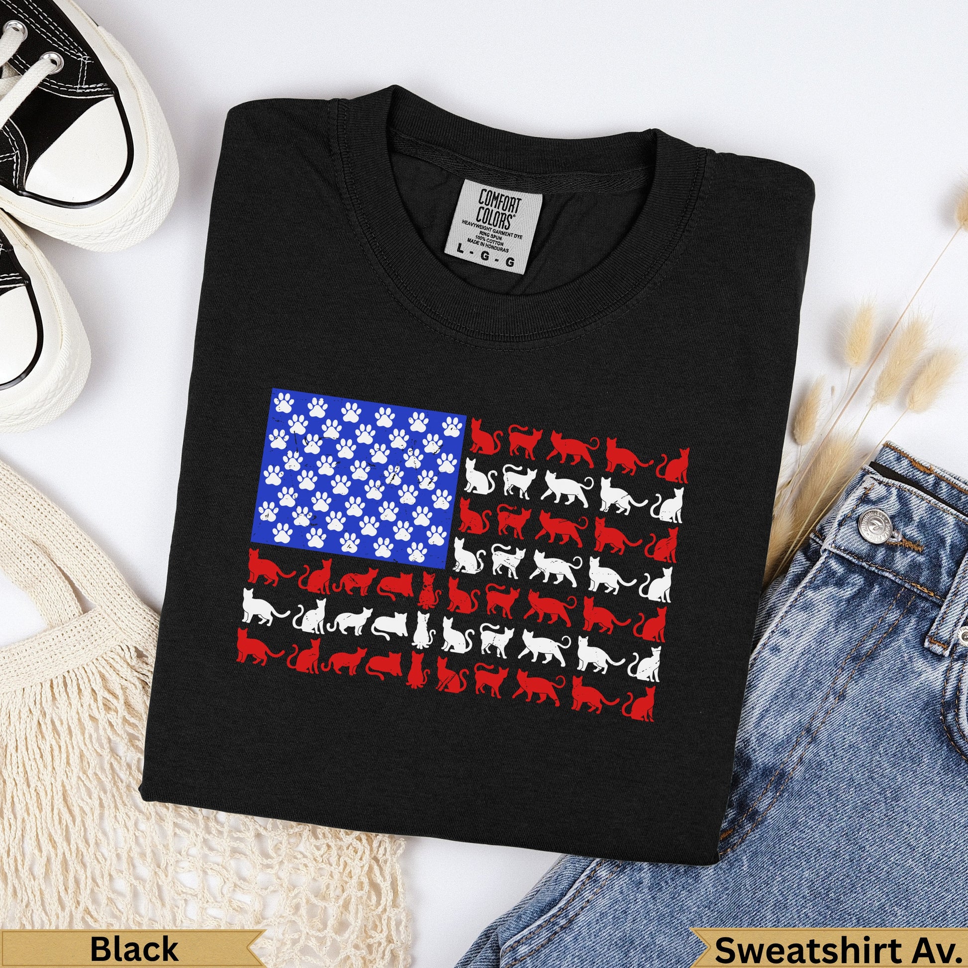 Black t-shirt with an American flag design made of cat silhouettes and paw prints.
