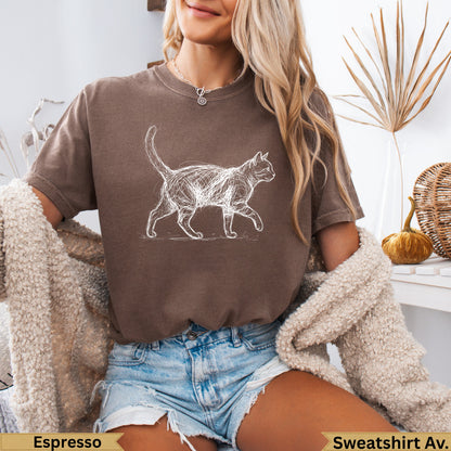 Sketch of a walking cat on a brown crewneck sweatshirt.