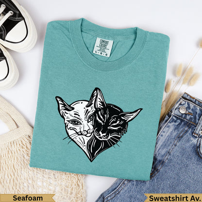 Teal t-shirt with black and white cat face design, "Seafoam" and "Sweatshirt Av.".