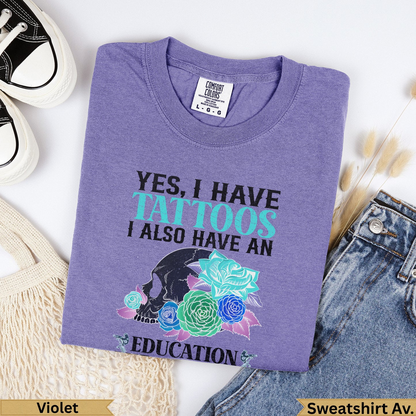 Violet Comfort Colors t-shirt with "Yes, I have tattoos, I also have an education" graphic.
