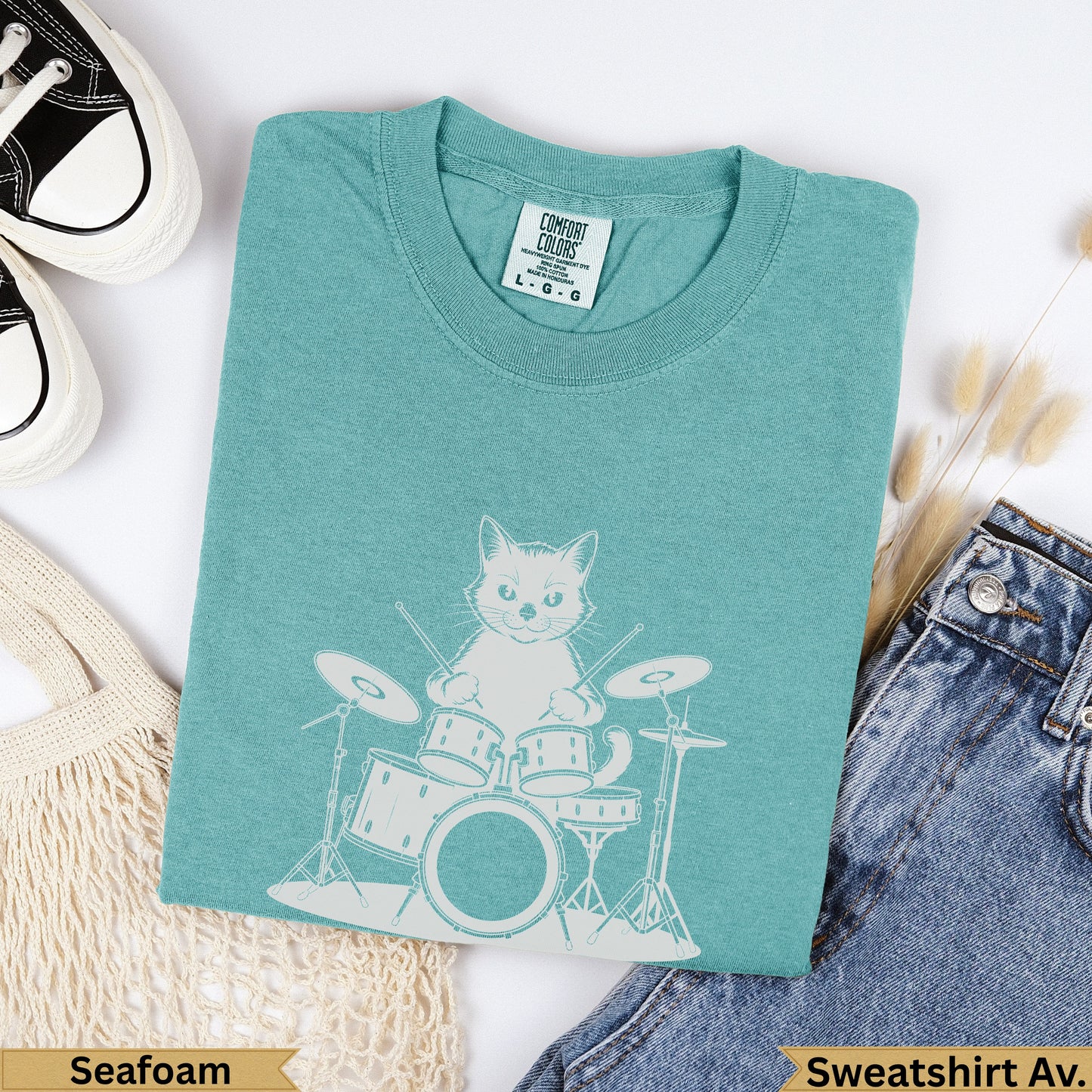 Seafoam Comfort Colors sweatshirt with a white graphic of a cat playing drums.