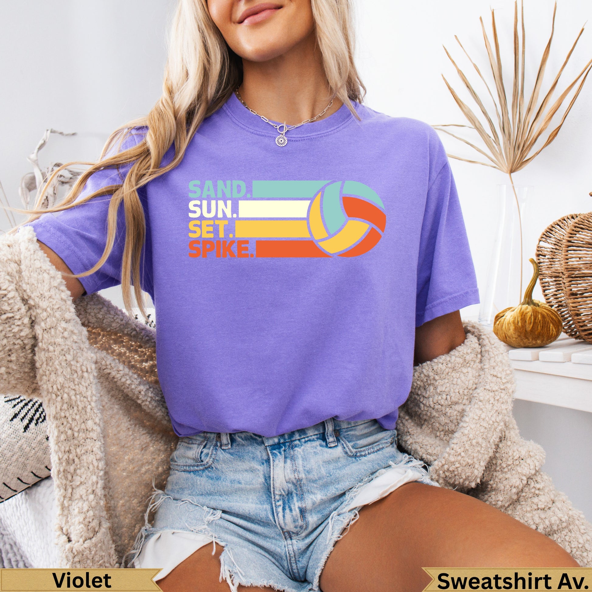 Purple t-shirt with "SAND SUN SET SPIKE" and a volleyball graphic.
