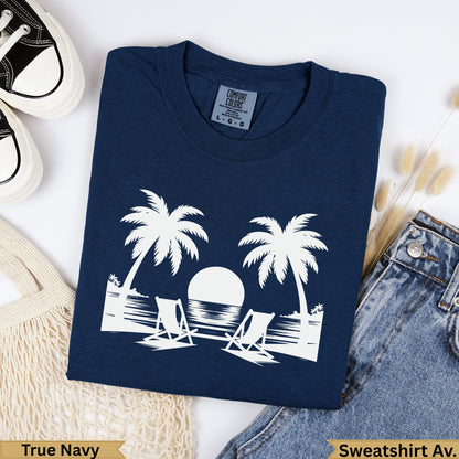 Navy blue Comfort Colors sweatshirt with palm trees, beach chairs, and ocean sunset graphic.