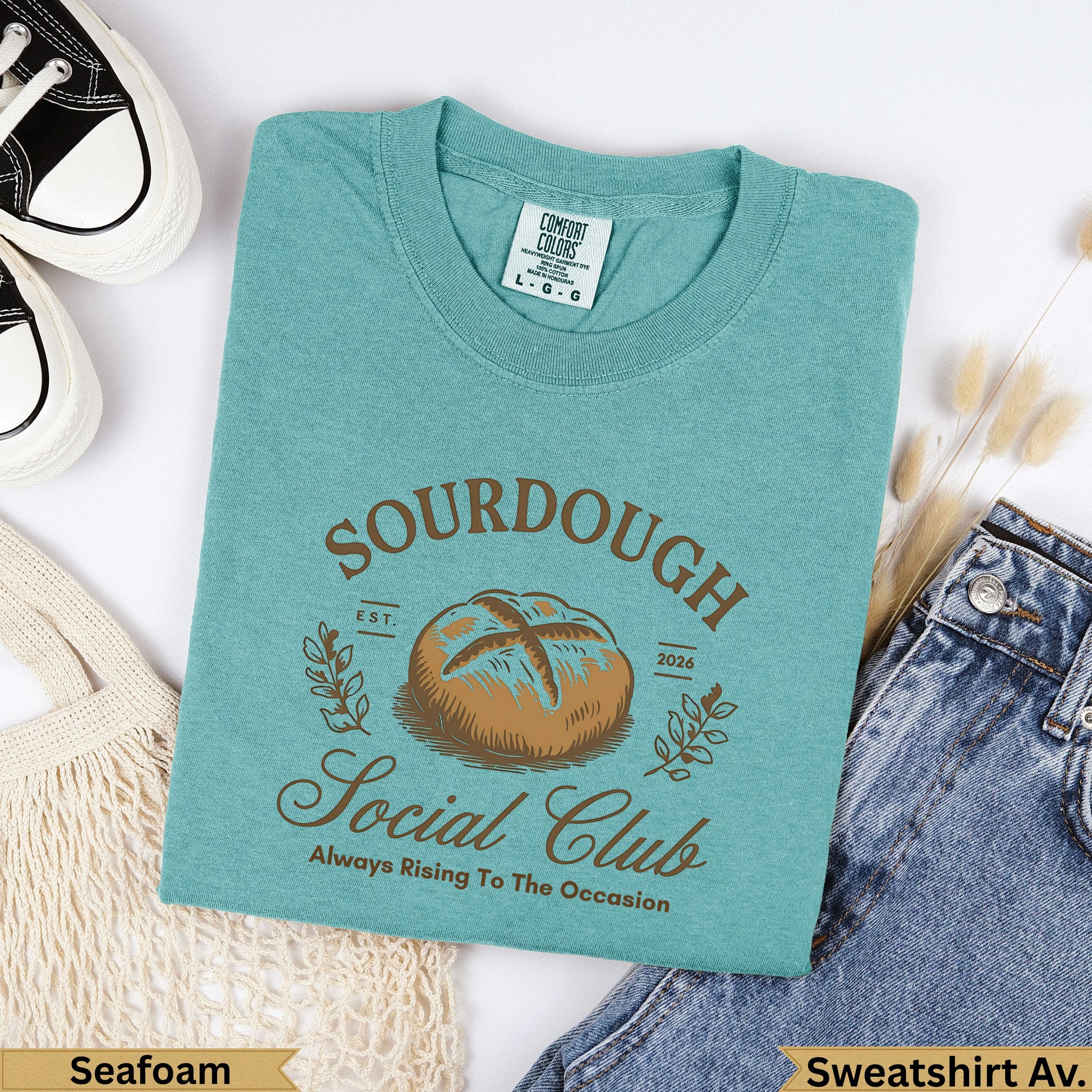 Teal graphic t-shirt with "Sourdough Social Club" text and a bread loaf graphic.