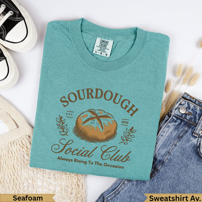 Teal graphic t-shirt with "Sourdough Social Club" text and a bread loaf graphic.
