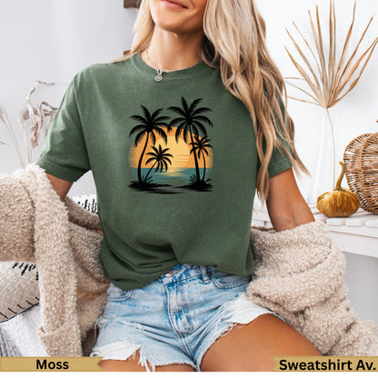 Moss green t-shirt with a sunset and palm tree graphic.