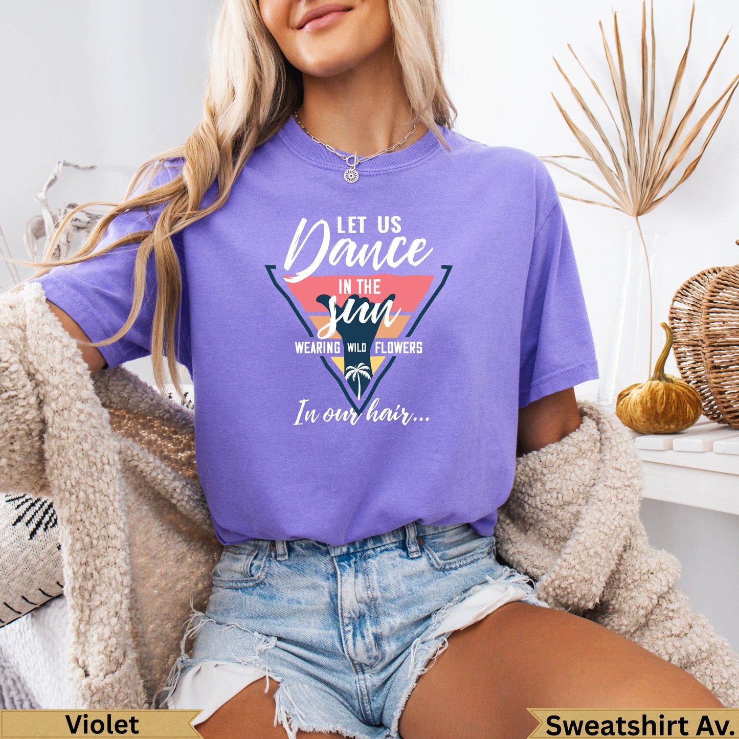 Purple t-shirt with "Dance in the sun" text and floral design.