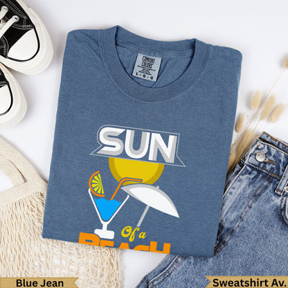 Blue t-shirt with "SUN of a beach" graphic and a white umbrella.