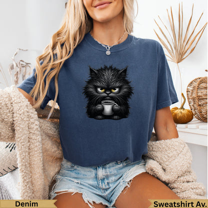 Grumpy black cat with coffee mug graphic on blue sweatshirt.