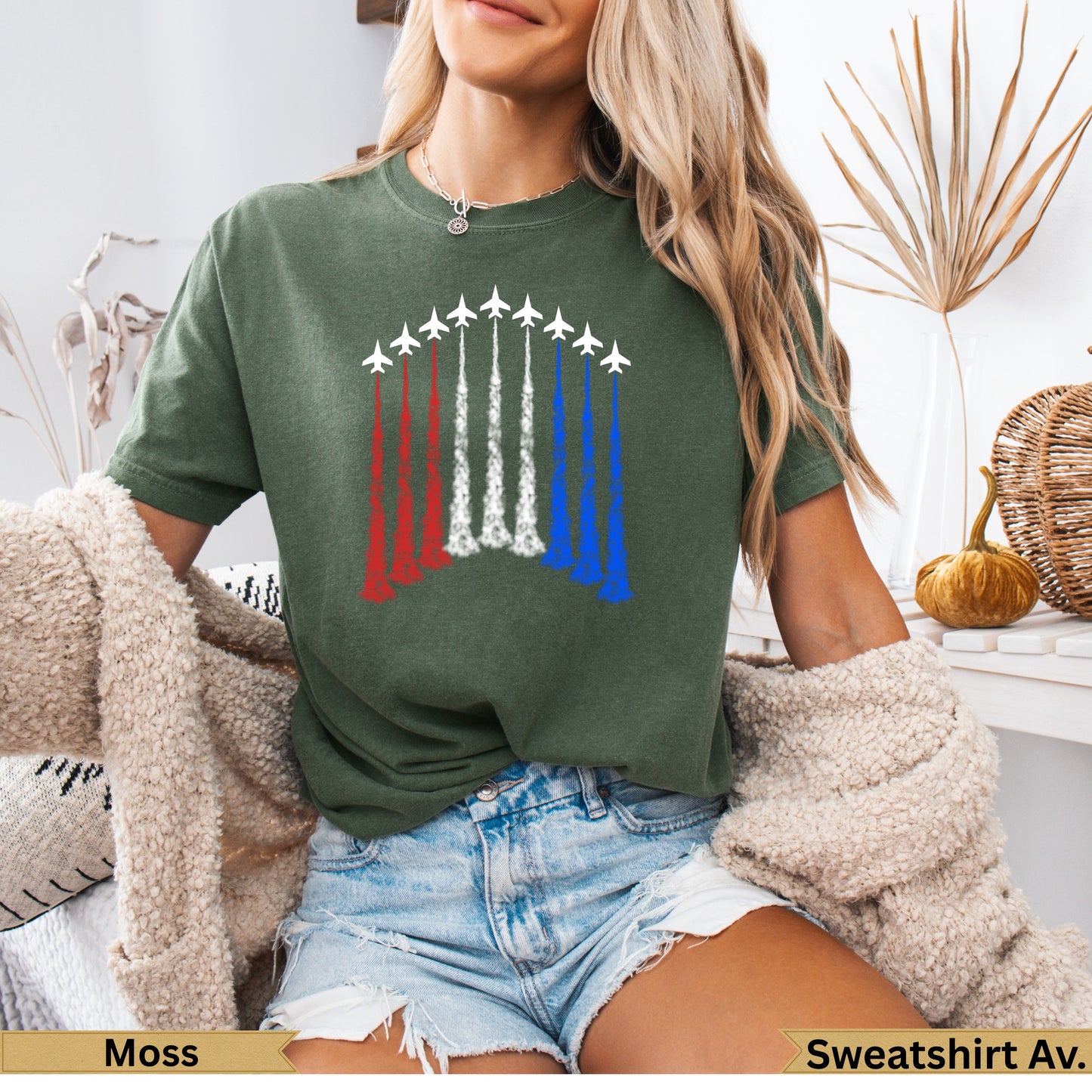 Green t-shirt with fighter jets leaving red, white, and blue smoke trails.