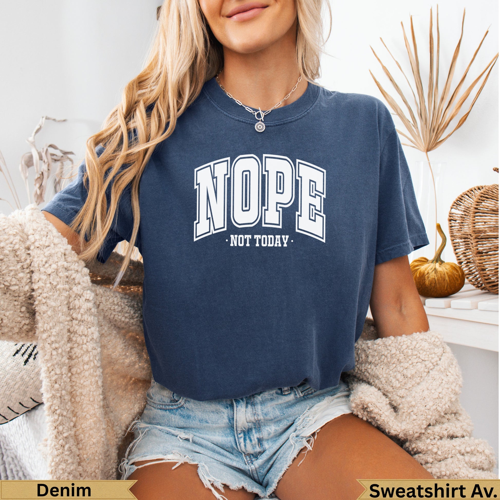 Woman wearing a navy blue t-shirt with "NOPE. NOT TODAY." text.