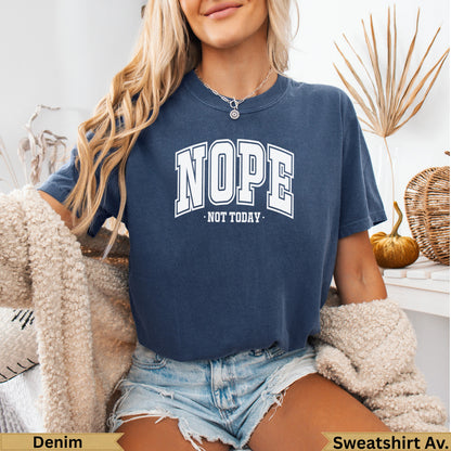 Woman wearing a navy blue t-shirt with "NOPE. NOT TODAY." text.