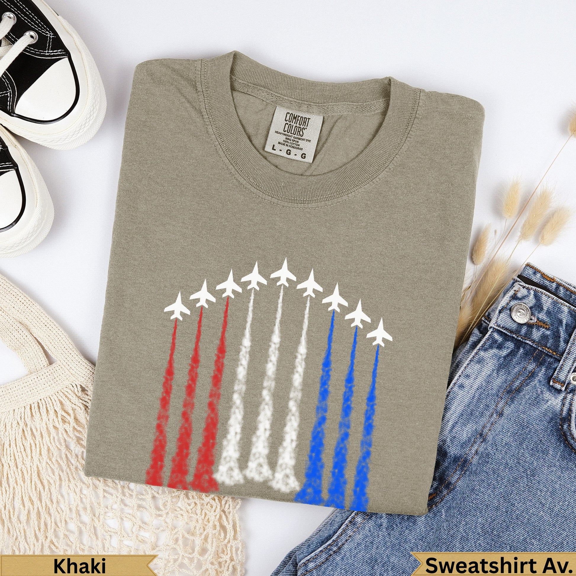 Khaki Comfort Colors t-shirt with red, white, and blue jet contrails.