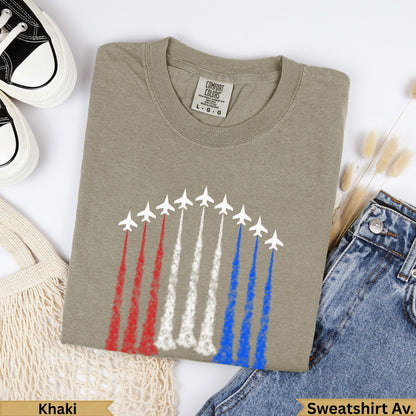 Khaki Comfort Colors t-shirt with red, white, and blue jet contrails.
