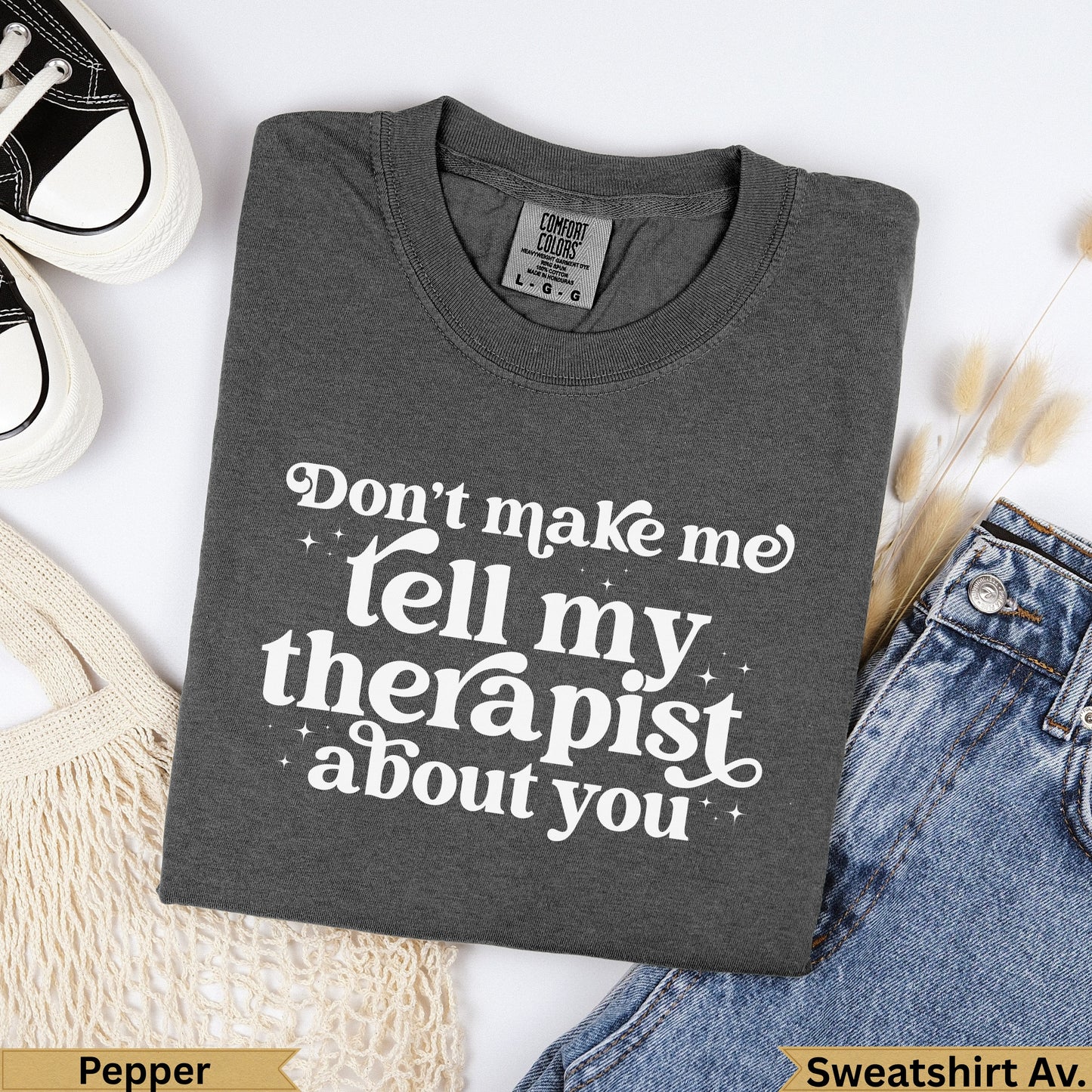 Dark grey graphic sweatshirt with "Don't make me tell my therapist about you" text.