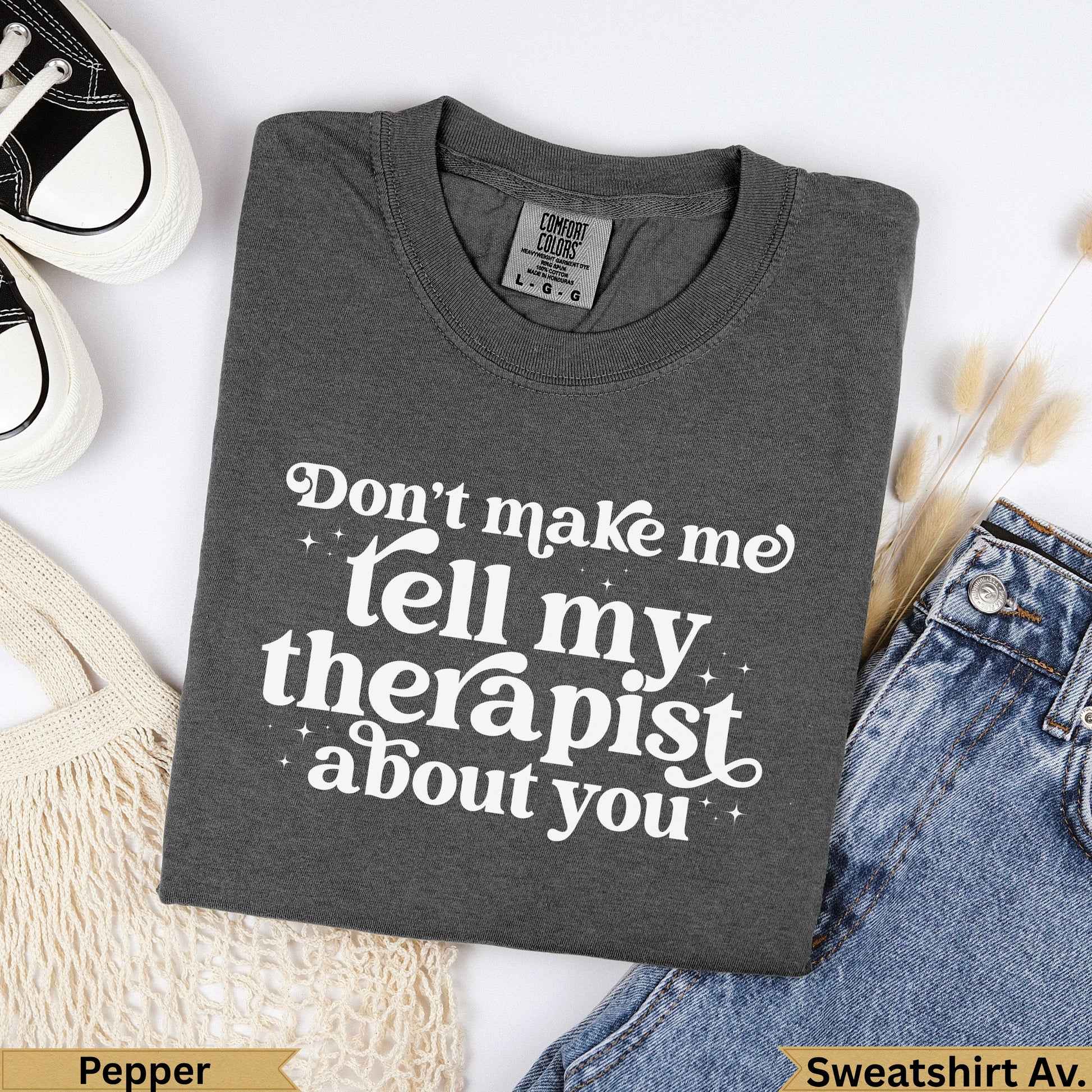 Dark grey graphic sweatshirt with "Don't make me tell my therapist about you" text.
