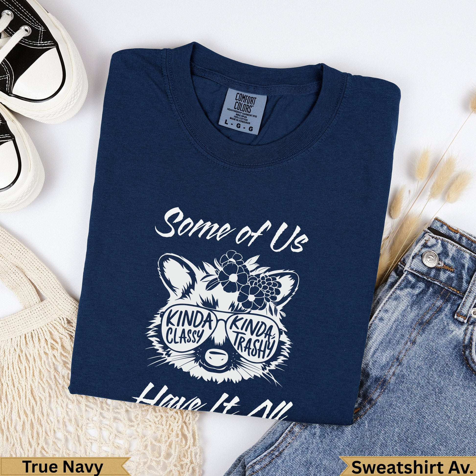 Navy sweatshirt with graphic of raccoon wearing sunglasses and text "Some of Us are KINDA CLASSY KINDA TRASHY".