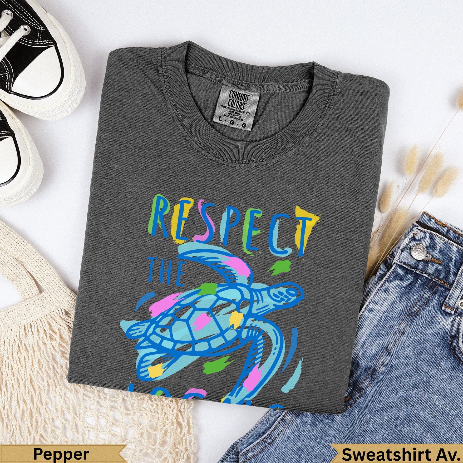 Dark grey Comfort Colors t-shirt with colorful sea turtle and "Respect the Ocean" text.