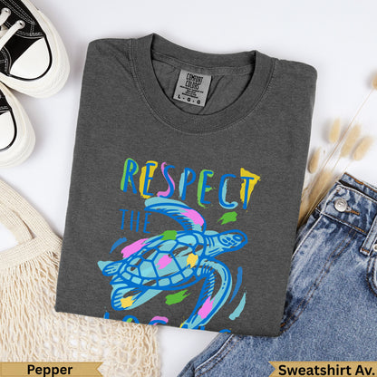Dark grey Comfort Colors t-shirt with colorful sea turtle and "Respect the Ocean" text.