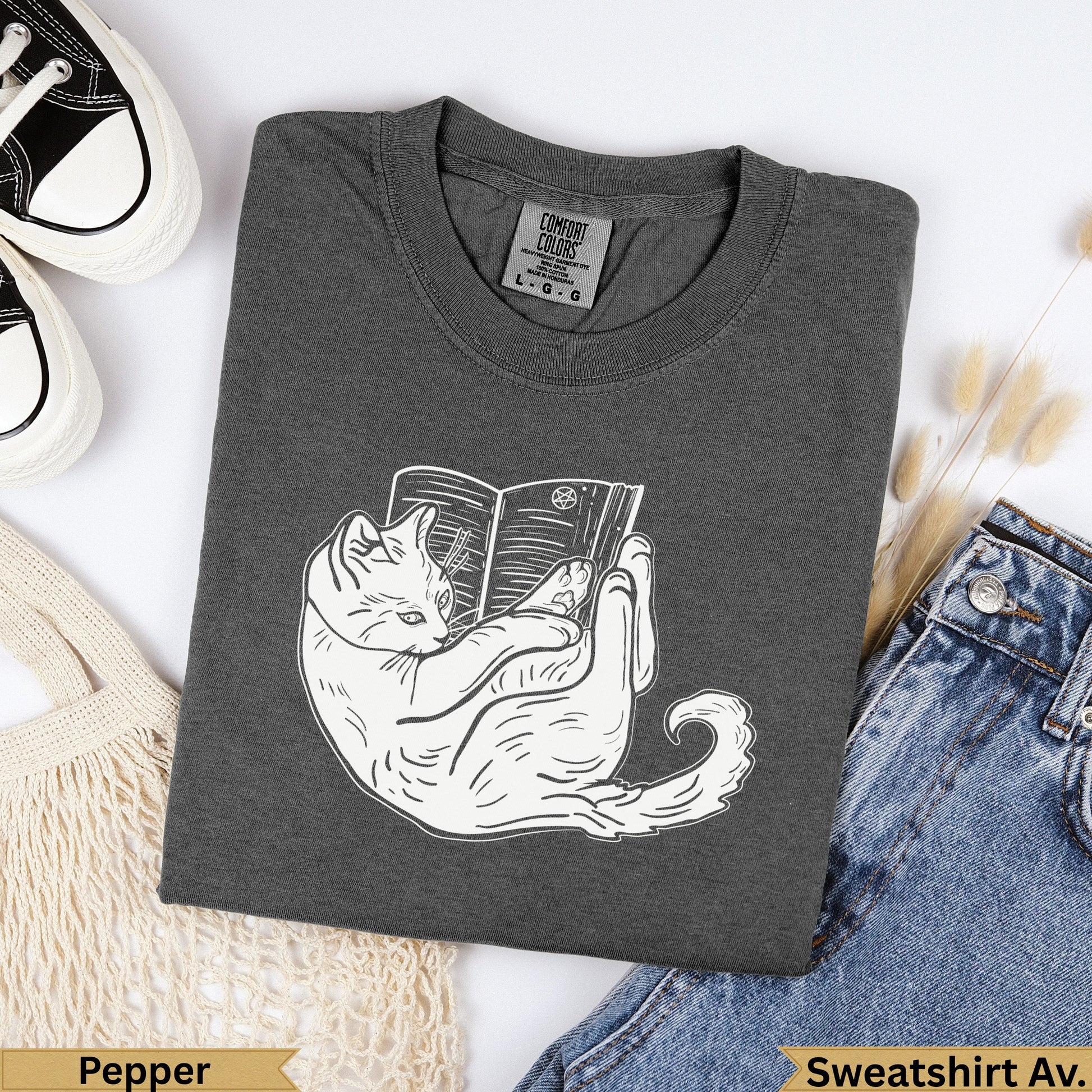 Dark gray Comfort Colors sweatshirt with white line drawing of a cat reading a book.
