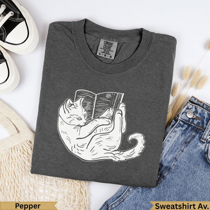 Dark gray Comfort Colors sweatshirt with white line drawing of a cat reading a book.
