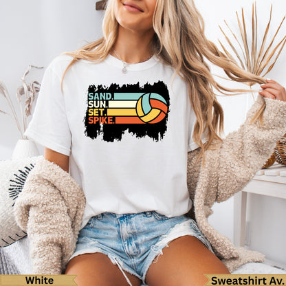 White t-shirt with "SAND. SUN. SET. SPIKE." and volleyball graphic.