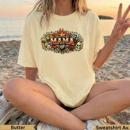 Light yellow graphic t-shirt with "MAMA" text and fiery, skull, and tattoo-style designs.
