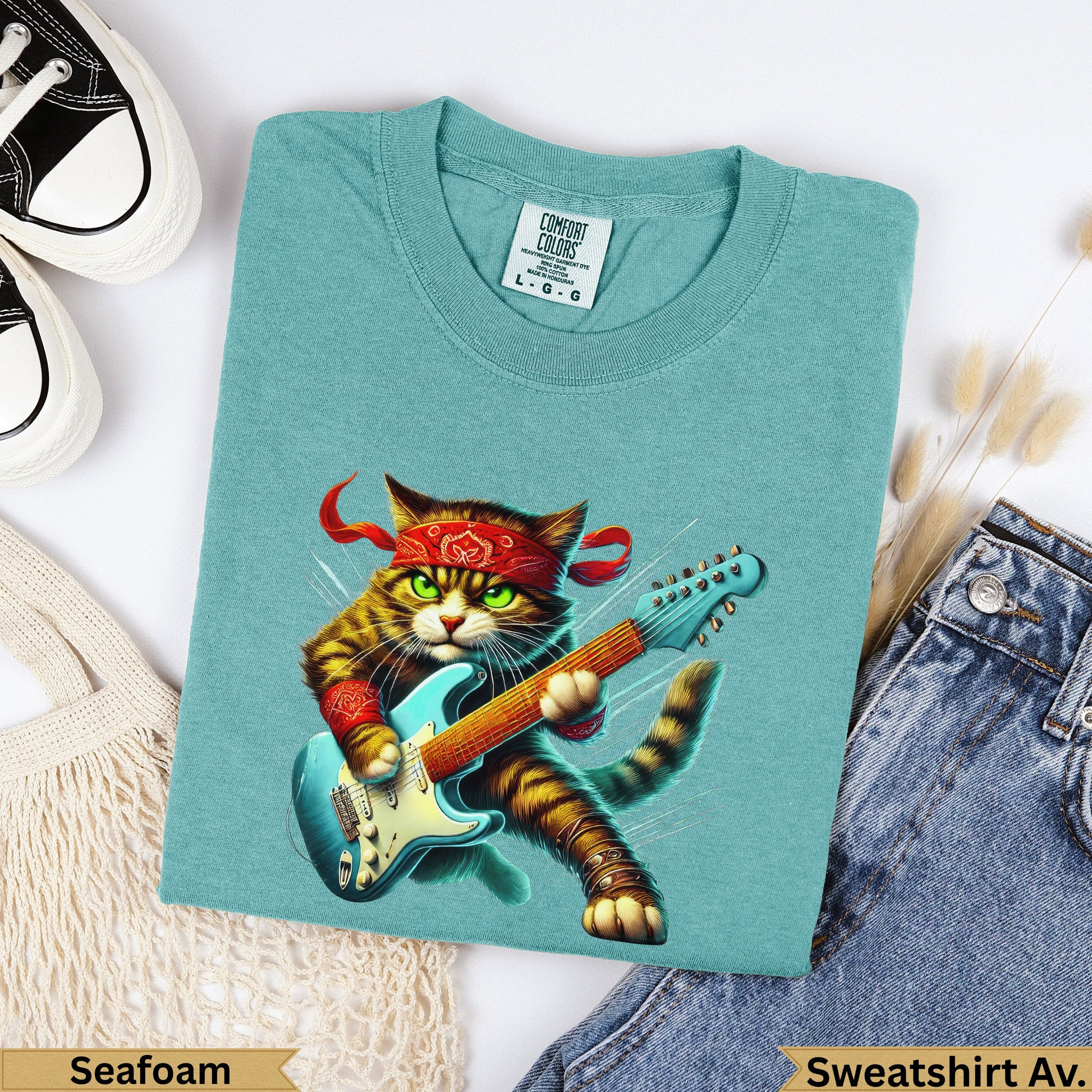 Teal t-shirt with cat playing electric guitar, text "Seafoam" and "Sweatshirt Av.".