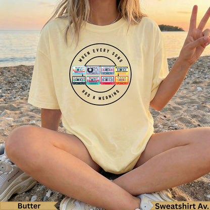 Yellow sweatshirt with "When Every Song Had a Meaning" and a cassette tape graphic.