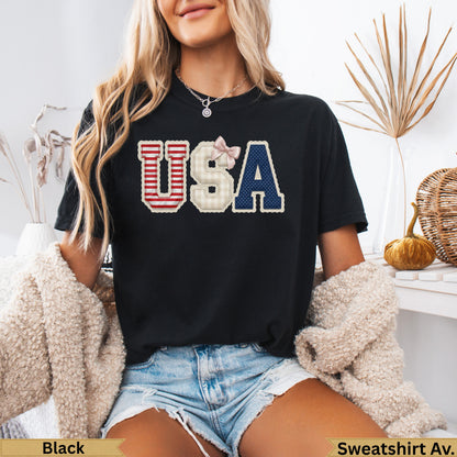 Black t-shirt with "USA" in red, white, and blue plaid and navy letters.