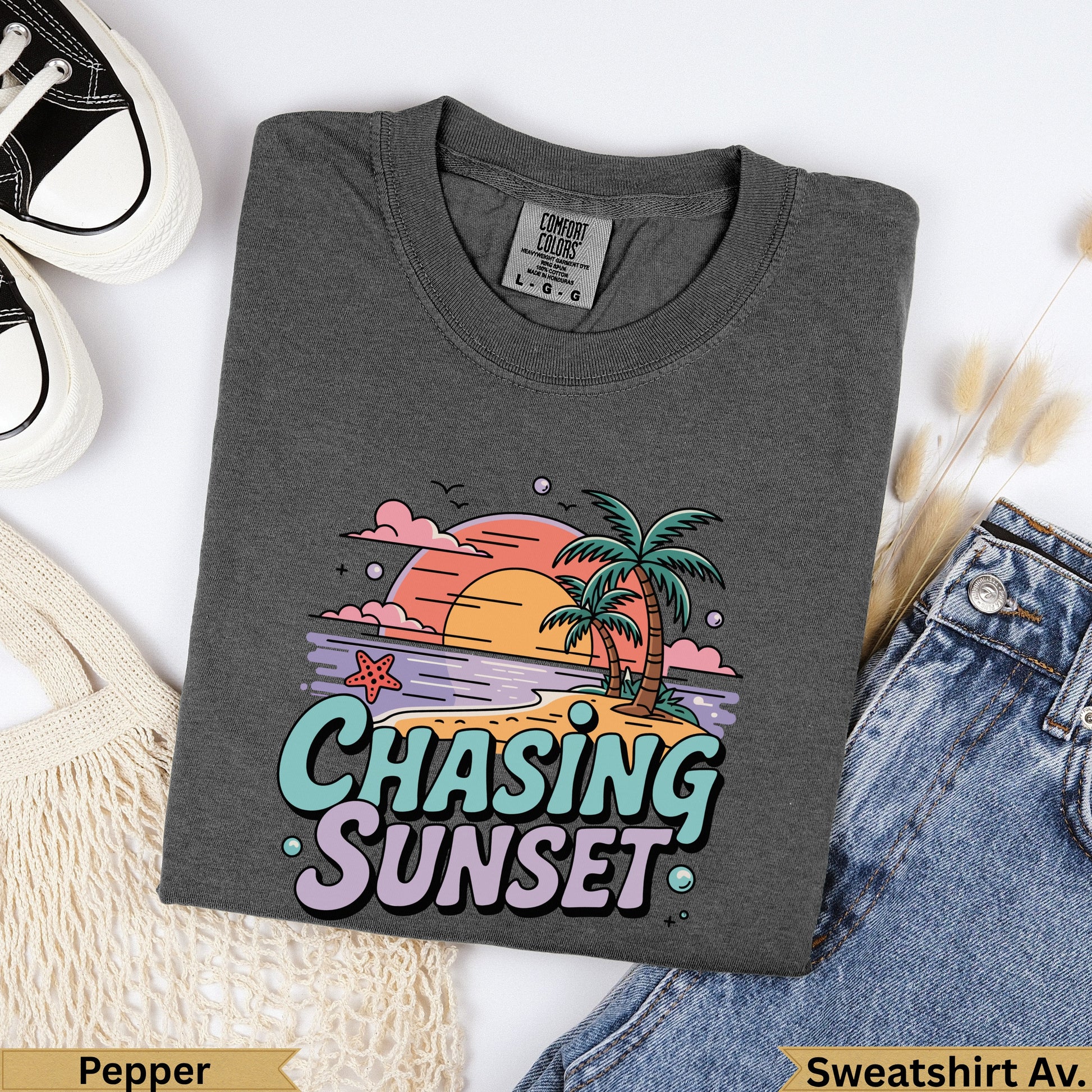 Dark grey t-shirt with "Chasing Sunset" graphic featuring palm trees and a sunset.