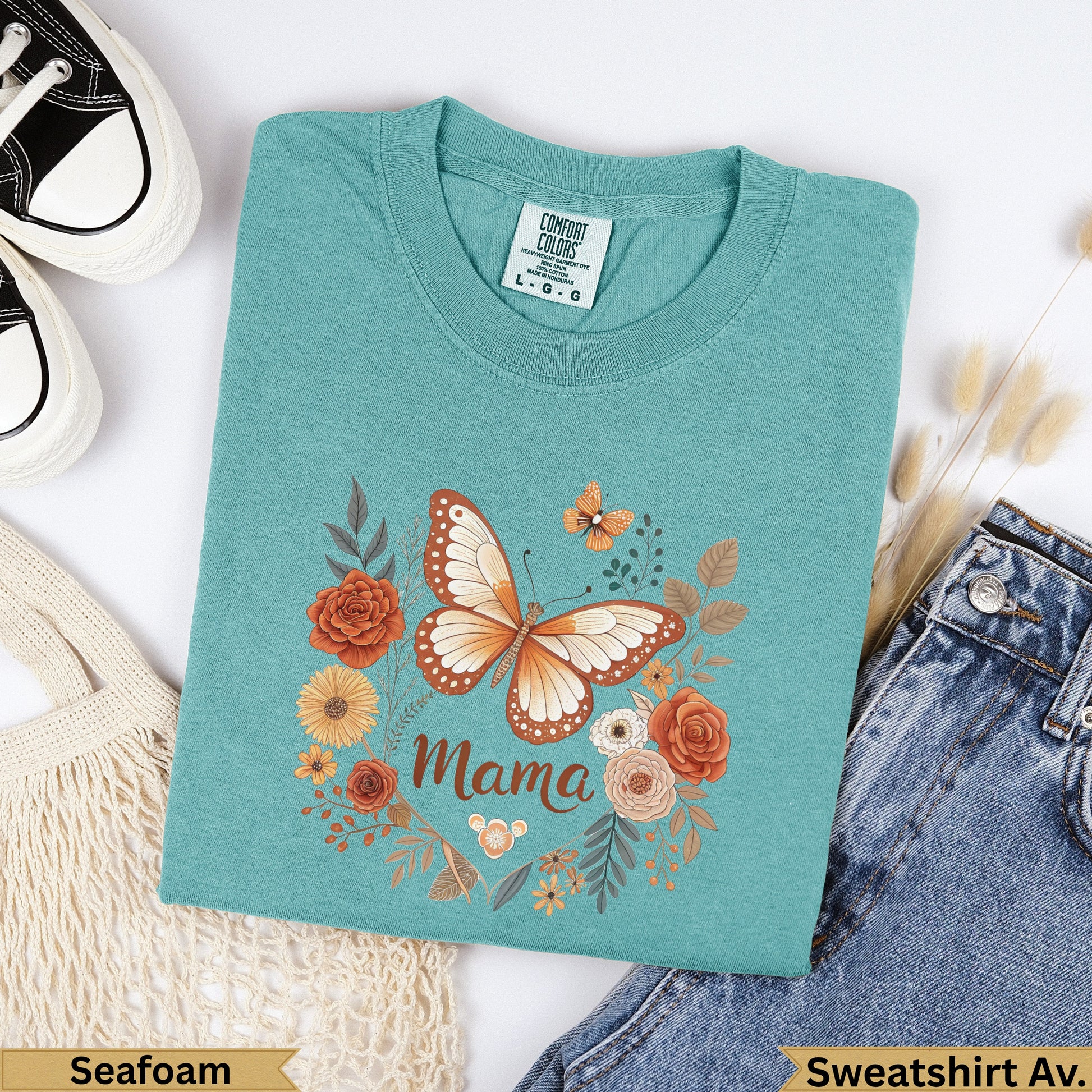 Teal t-shirt with "Mama" and butterfly design, surrounded by flowers.