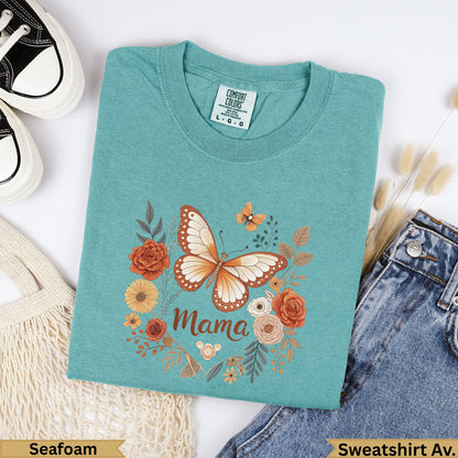 Teal t-shirt with "Mama" and butterfly design, surrounded by flowers.