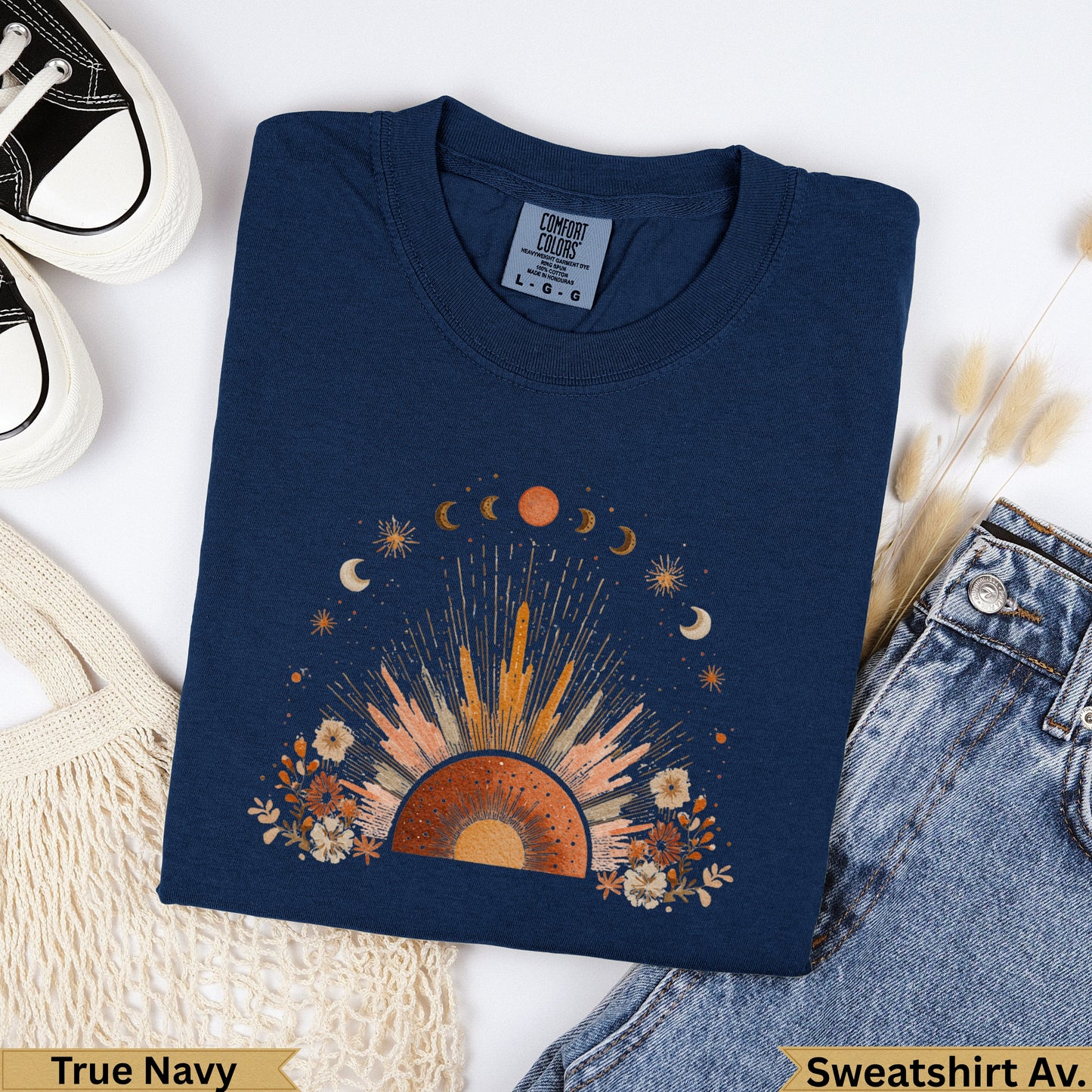 Navy crewneck sweatshirt with sun, moon, and celestial floral graphic.