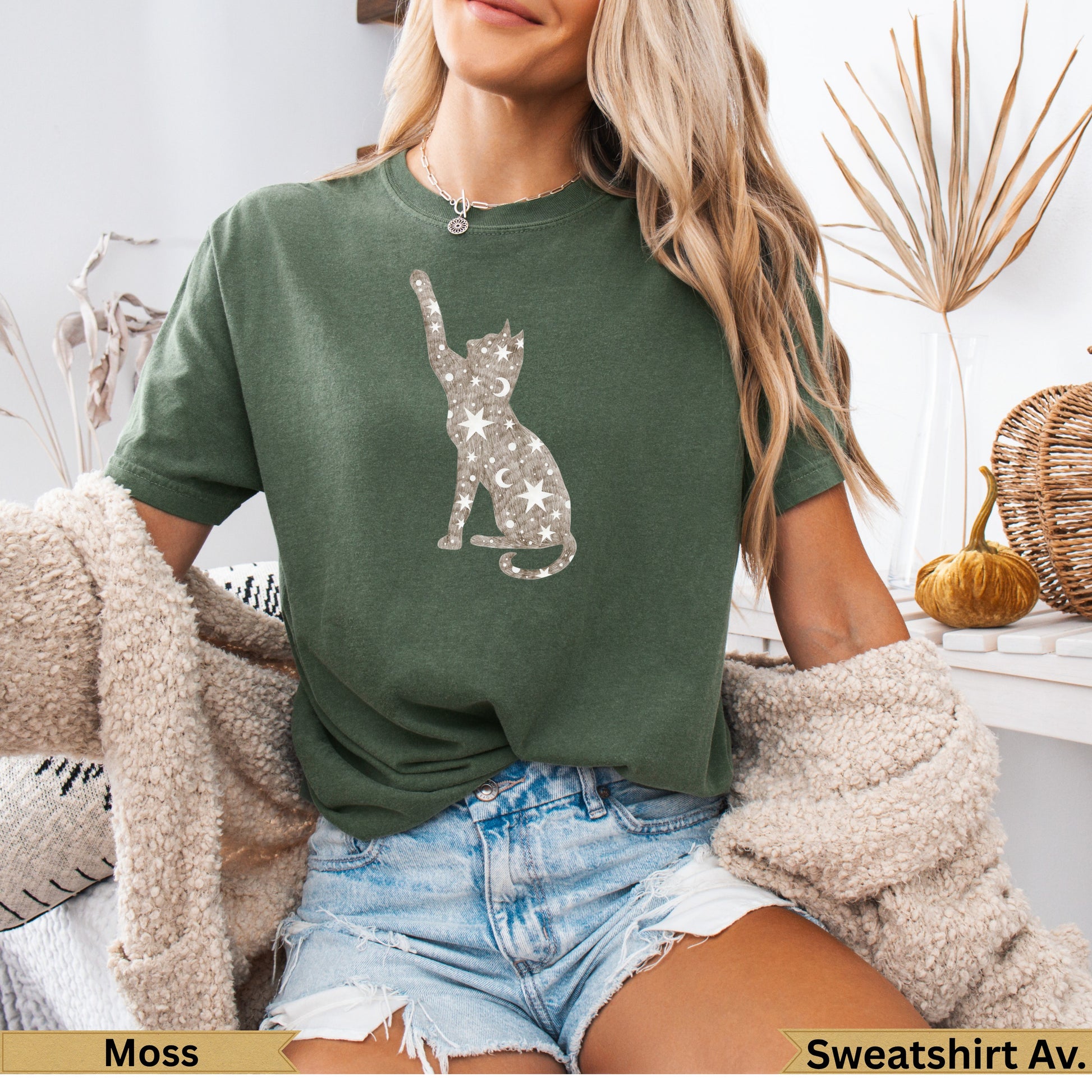Green t-shirt with a constellation cat graphic.